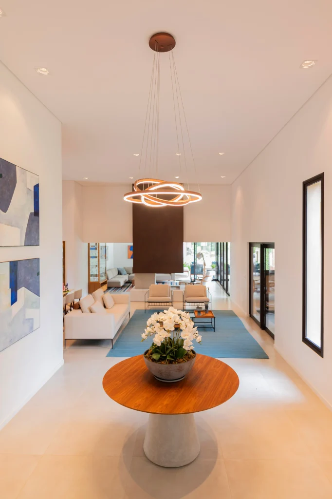 <img src="sala-de-estar-moderno-com-iluminacao-e-arte.webp" alt="imagem de um ambiente de sala de estar moderna com iluminação elegante, mesa de centro, sofá confortável, obras de arte nas paredes e janelas que deixam a luz natural entrar.">